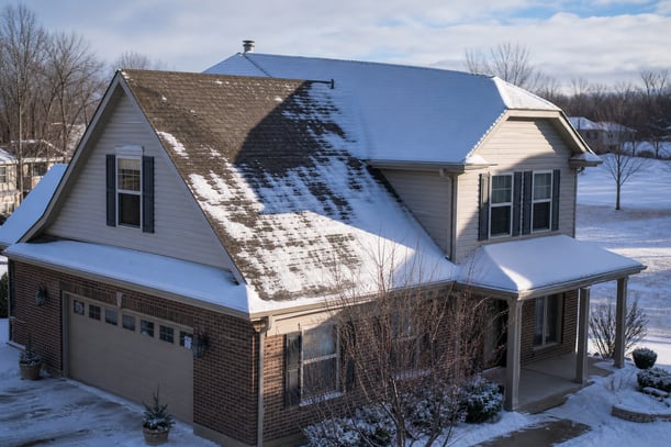 Suburban Home Roof Snow Melt Sunlight Contrast